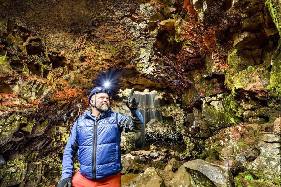 From Reykjavik: Raufarhólshellir Lava Tunnel by Bus - First steps in the lava tunnel, where columns of light set the mood