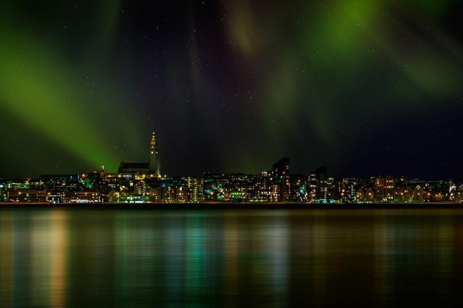 Reykjavik: Northern Lights Motor Yacht Cruise - Harpa and Sun Voyager: Reykjavik’s night skyline from the water